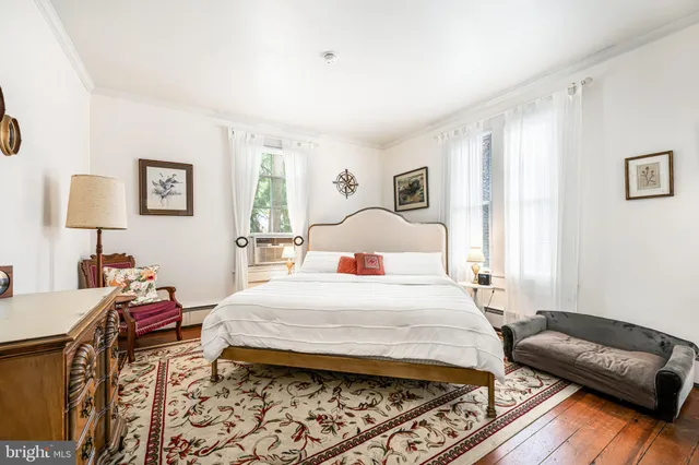 a bedroom with a bed and a dresser