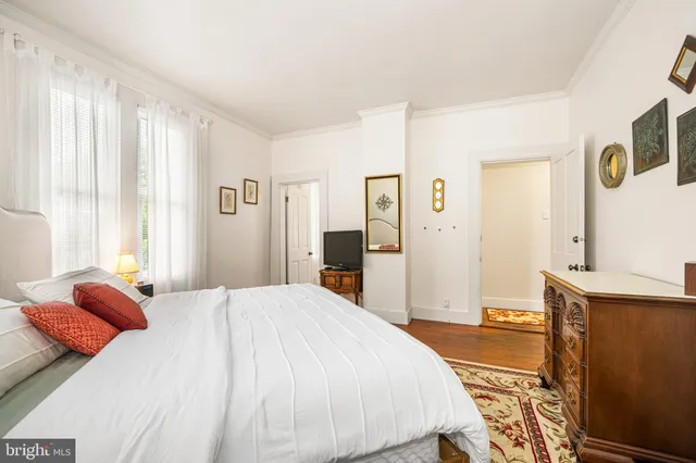 a bedroom with a bed and a desk