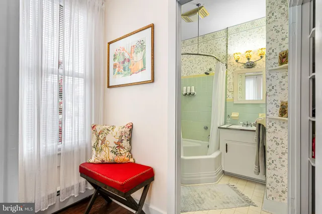 a view of a house with potted plants and a large tree