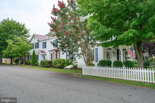 a view of a house with a small yard and plants