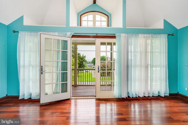 an empty room with wooden floor and closet