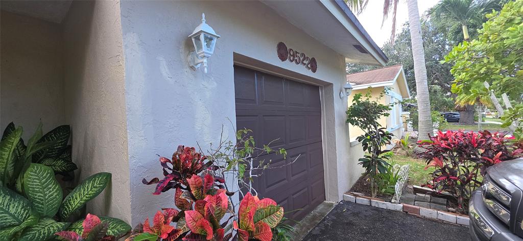 9522 Affirmed Lane Boca Raton, FL 33496 - Photo 1 of 10 a vase with flowers sitting on a floor