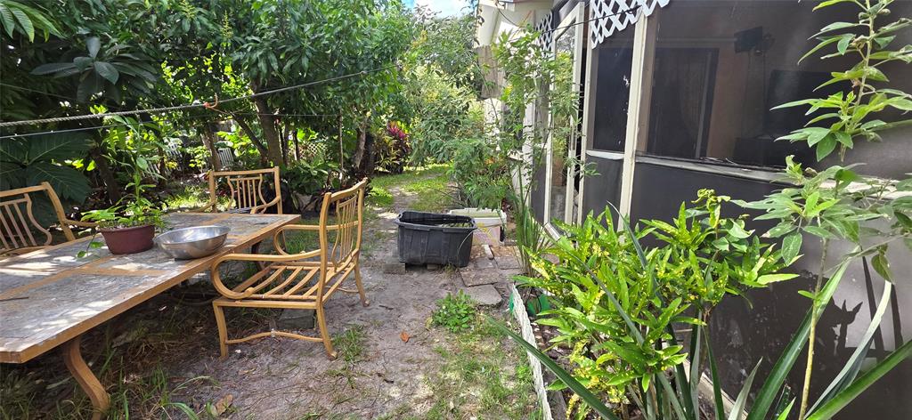 9522 Affirmed Lane Boca Raton, FL 33496 - Photo 10 of 10 a backyard of a house with table and chairs
