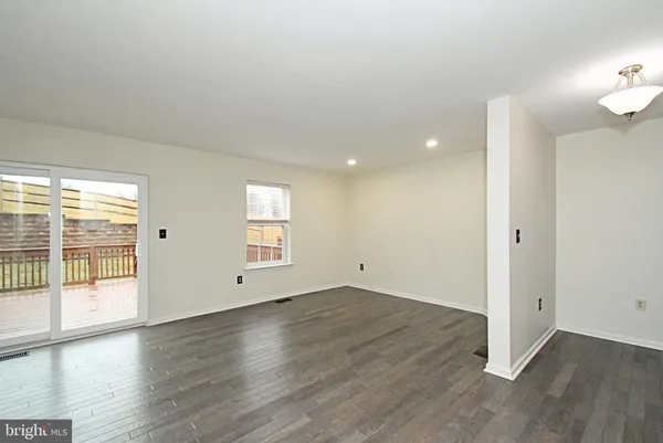 a large kitchen with stainless steel appliances granite countertop a sink cabinets and wooden floor