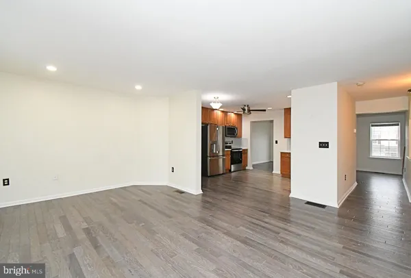 a kitchen with a sink cabinets and wooden floor