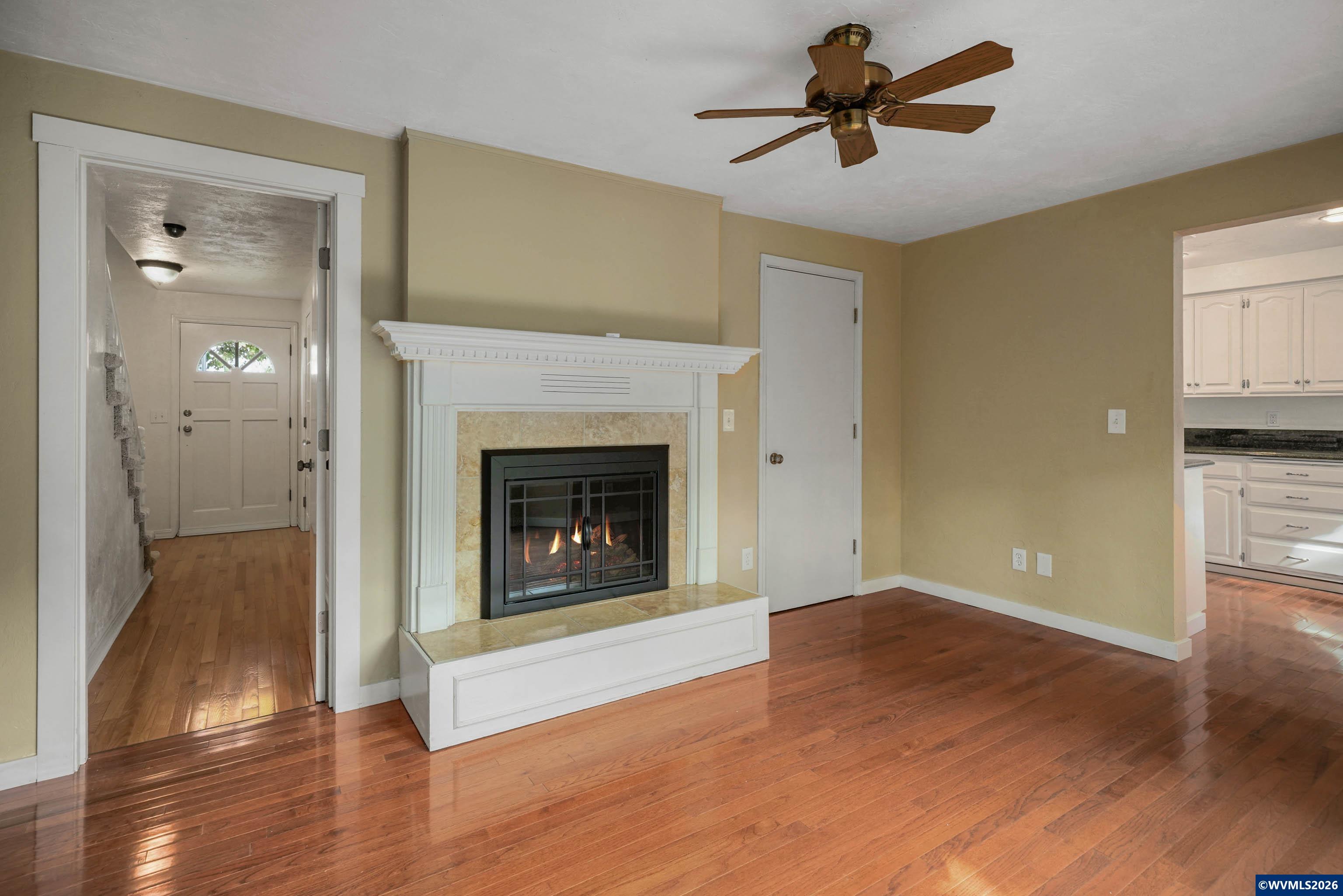 220 Northwest Downy Drive Sublimity, OR 97385 - Photo 12 of 47 a view of a livingroom with a fireplace and a chandelier fan