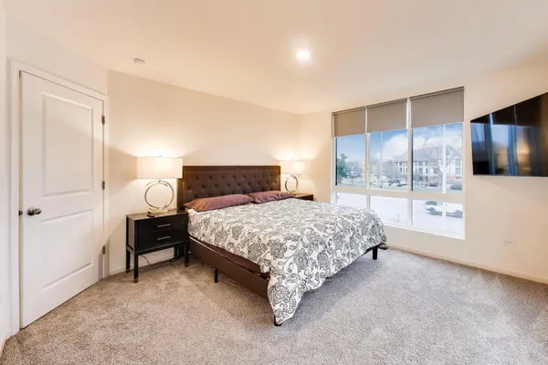 a bedroom with a large bed and a tv