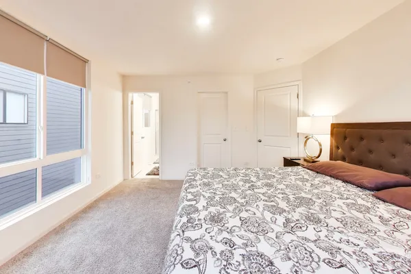 a bedroom with a large bed and a large window