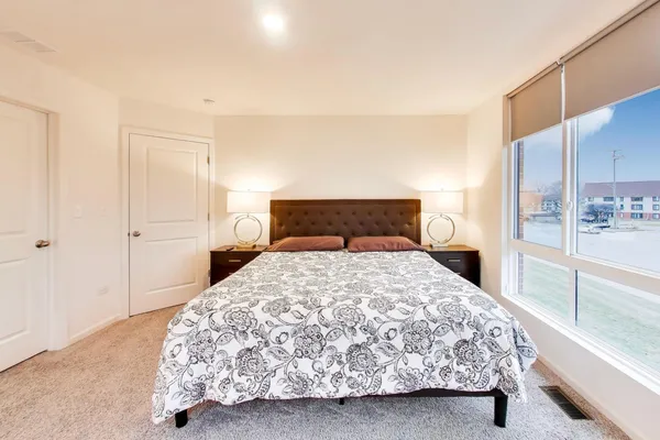a bedroom with a bed and walk in closet