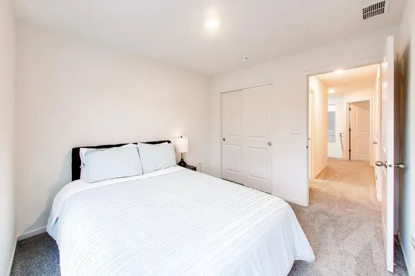 a bedroom with a bed and a view of bathroom
