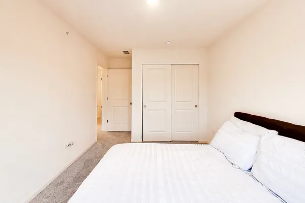 a bedroom with a bed and a cabinets