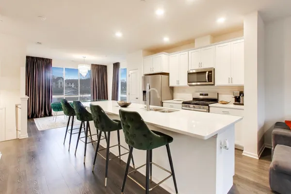 a kitchen with kitchen island wooden cabinets and stainless steel appliances