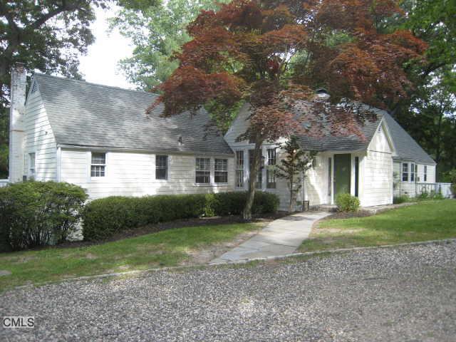 34 Cranbury Road Westport, CT 06880 - Photo 1 of 1 a front view of a house with a yard and garage