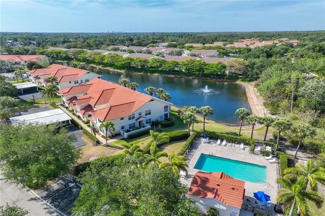 an aerial view of residential houses with outdoor space and lake view