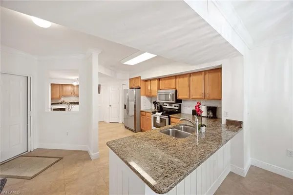 a kitchen view with dining table and chair