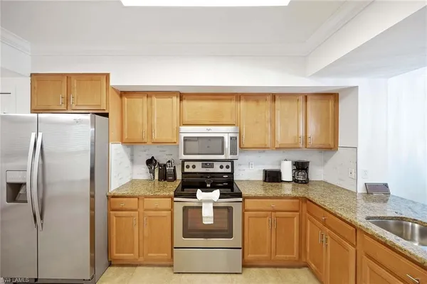a kitchen with a refrigerator stove and sink