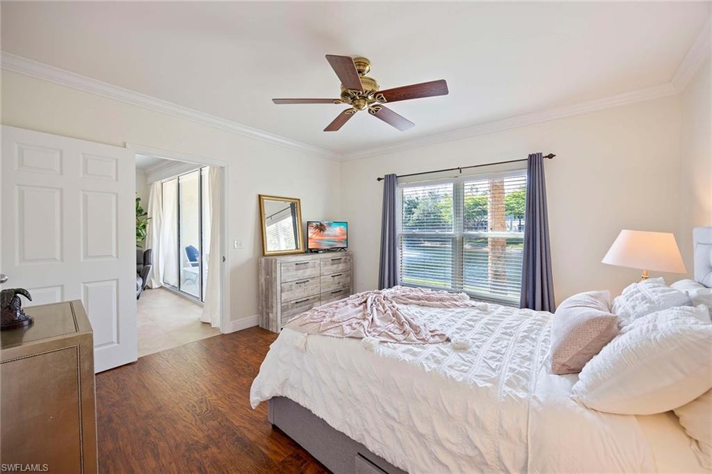 5455 Worthington Lane, Unit 103 Naples, FL 34110 - Photo 20 of 38 a bedroom with a bed and a large window