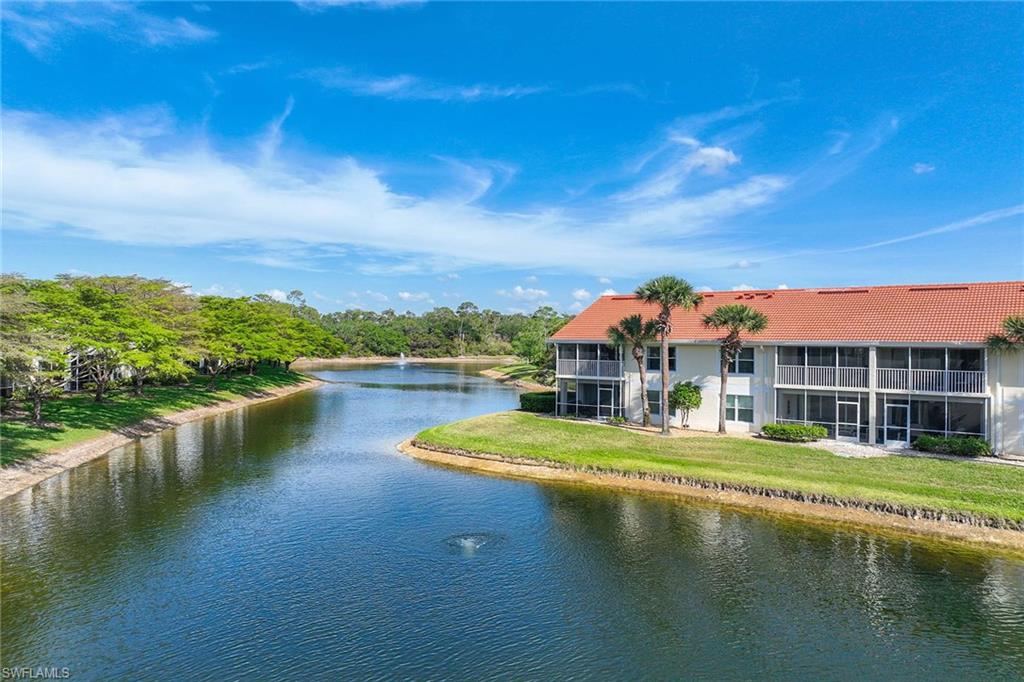 5455 Worthington Lane, Unit 103 Naples, FL 34110 - Photo 31 of 38 a view of a lake with a big yard