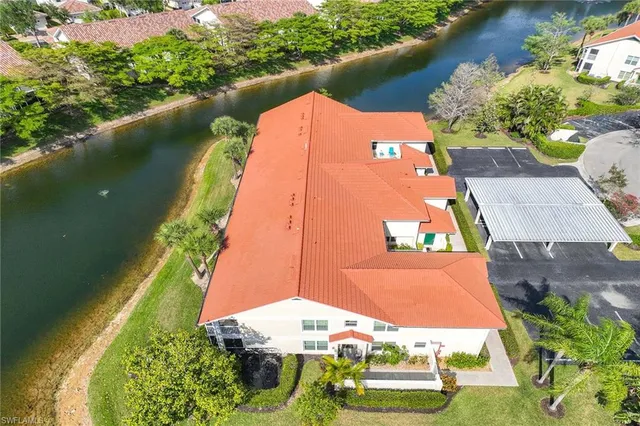 an aerial view of a house with a garden and lake view