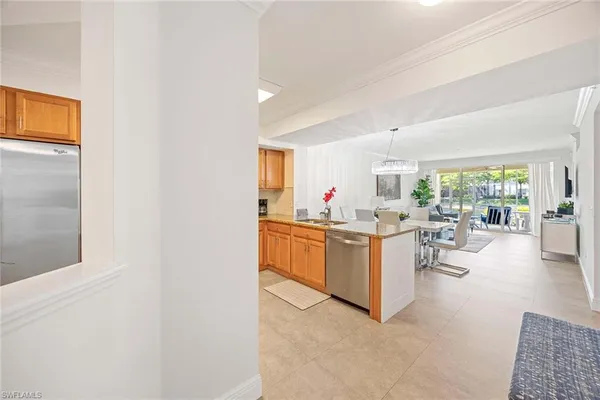 a kitchen with stainless steel appliances granite countertop a refrigerator and a stove top oven