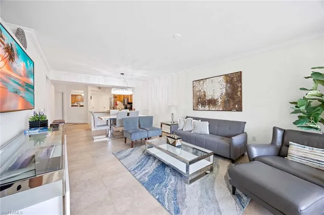 a living room with furniture and a painting on the wall