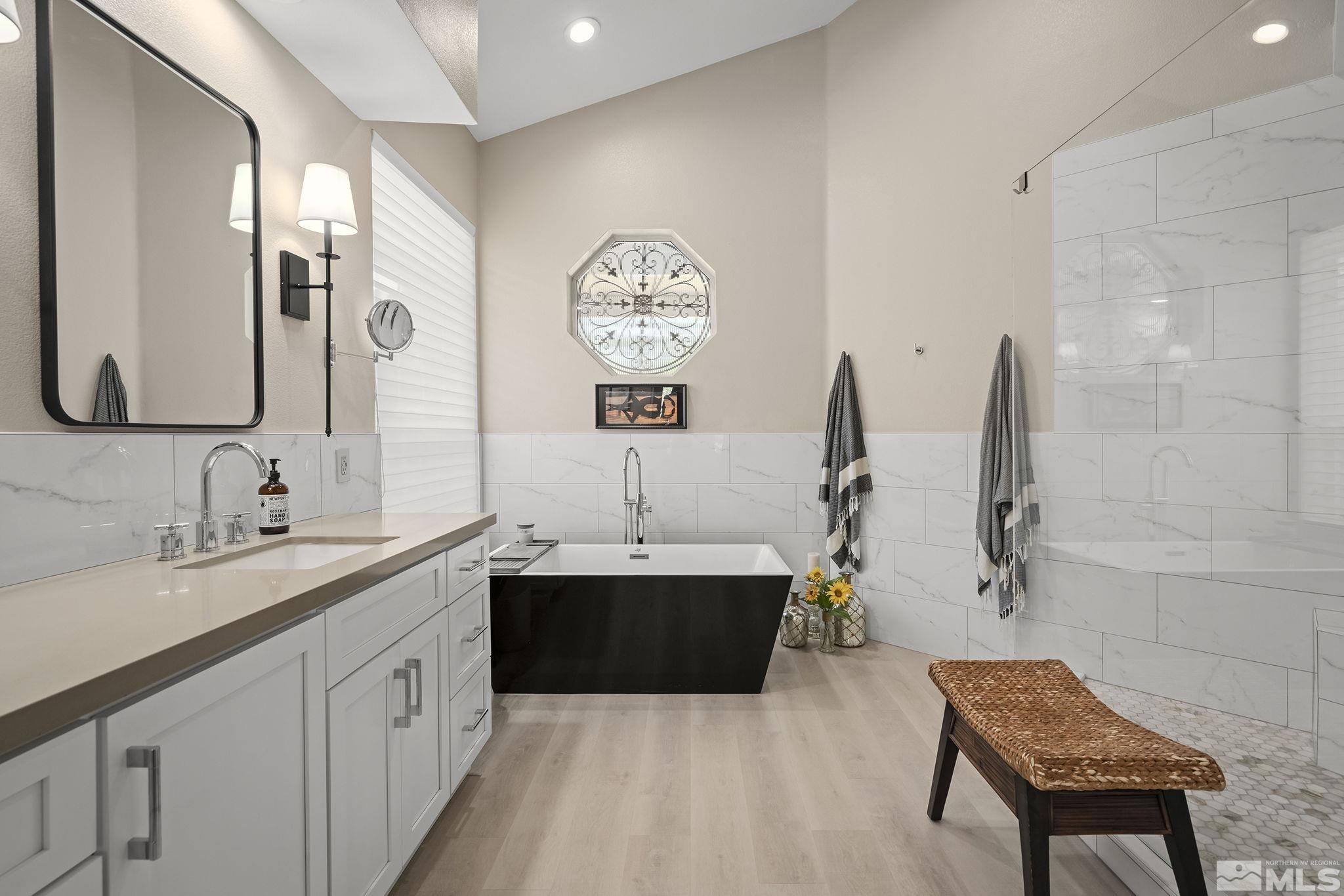 6156 Wycliffe Circle Reno, NV 89519 - Photo 14 of 30 a spacious bathroom with a tub sink and mirror