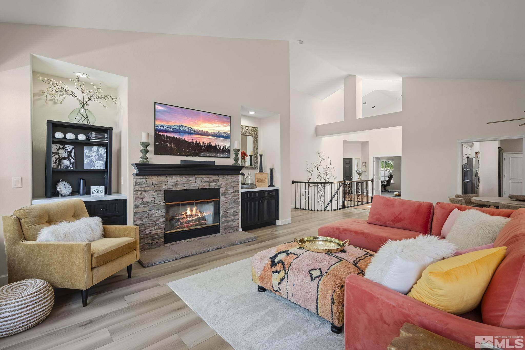 6156 Wycliffe Circle Reno, NV 89519 - Photo 6 of 30 a living room with furniture a flat screen tv and a fireplace
