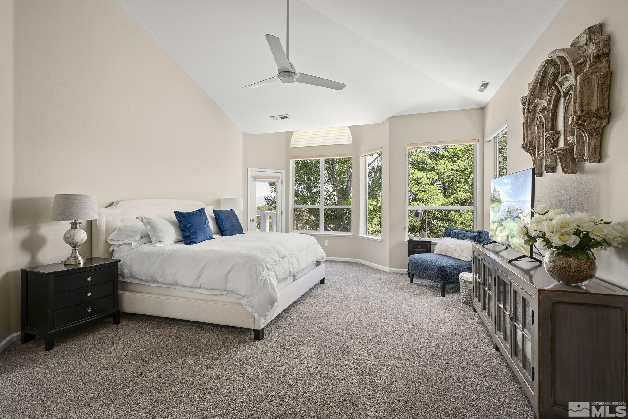 6156 Wycliffe Circle Reno, NV 89519 - Photo 10 of 30 a spacious bedroom with a bed and a couch