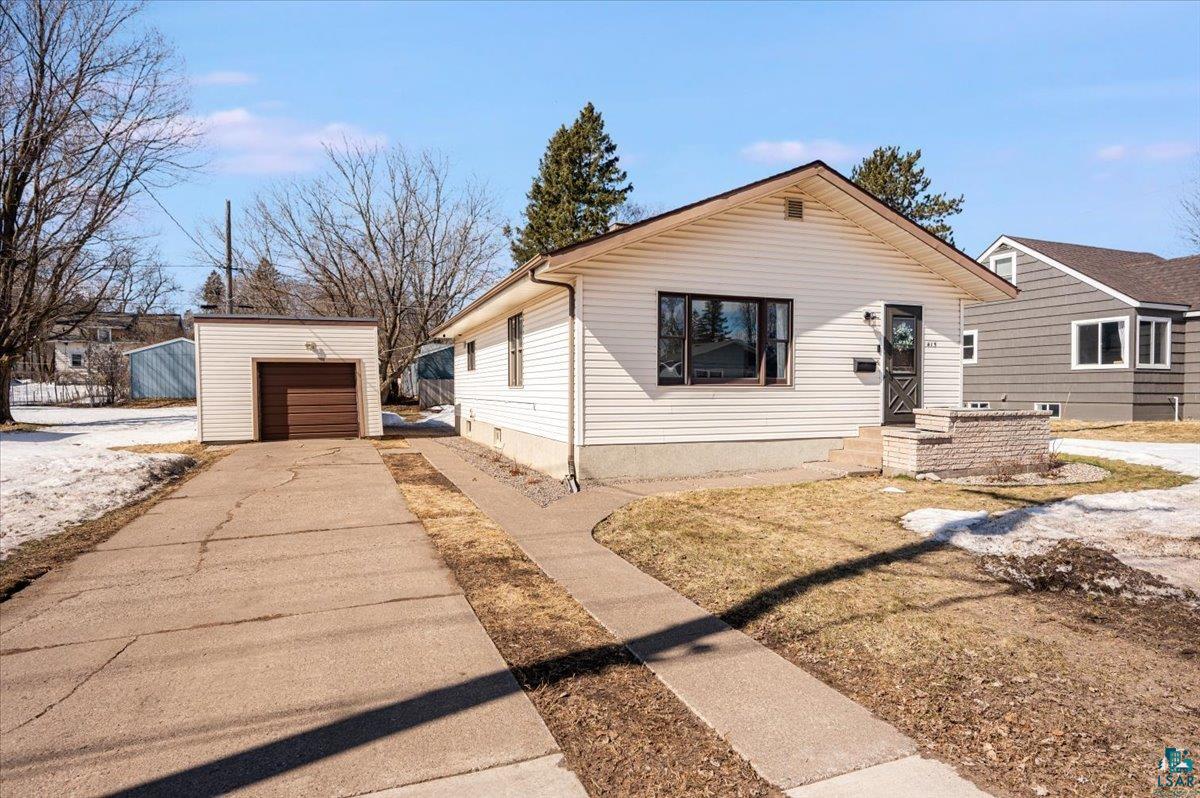 415 14th Street Cloquet, MN 55720 - Photo 1 of 20 View of front facade with concrete driveway, an outbuilding, and a detached garage