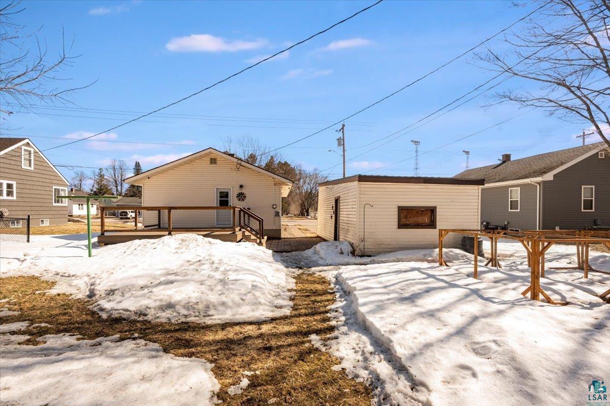 415 14th Street Cloquet, MN 55720 - Photo 15 of 20 Snow covered rear of property featuring a deck