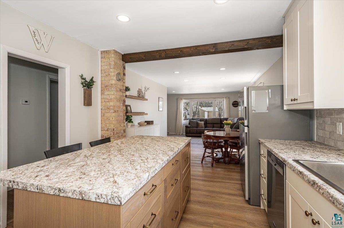 415 14th Street Cloquet, MN 55720 - Photo 20 of 20 Two tone kitchen with recessed lighting, open floor plan, two tone cabinets, a center island, and dark wood finished floors