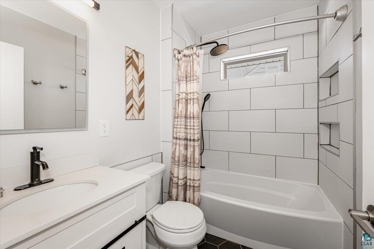 415 14th Street Cloquet, MN 55720 - Photo 6 of 20 Bathroom featuring vanity and shower / bath combo with shower curtain