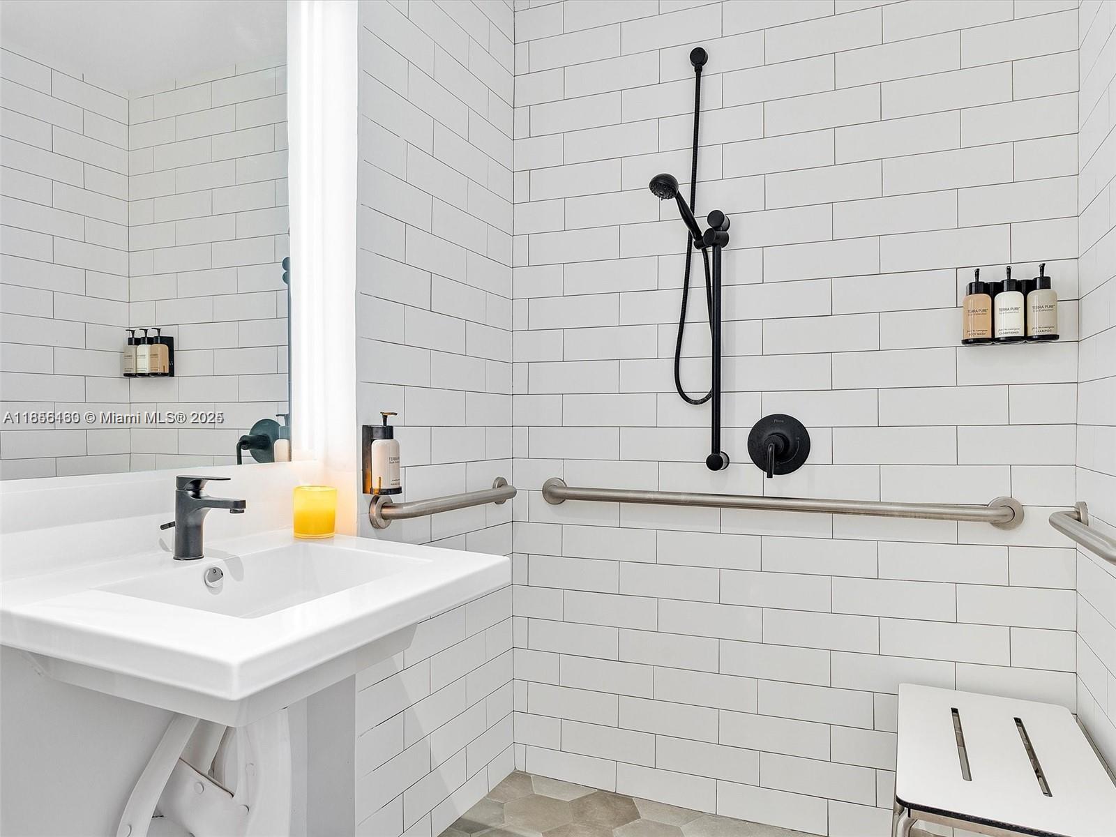 398 Northeast 5th Street, Unit 1915 Miami, FL 33132 - Photo 9 of 15 a bathroom with a sink a toilet and shower