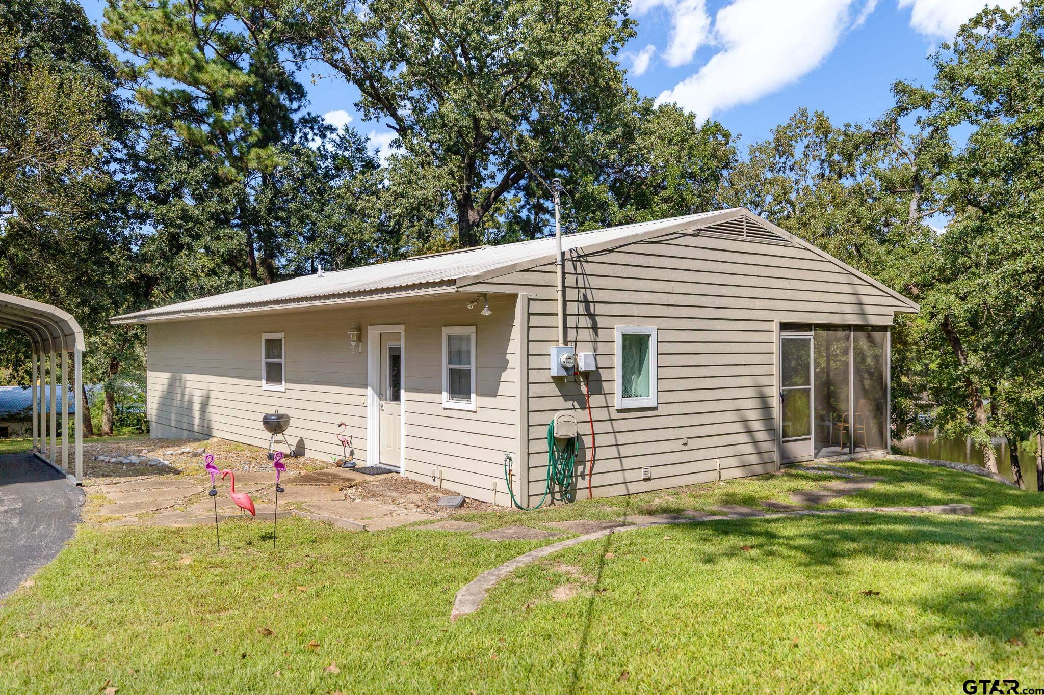 a backyard of a house with table and chairs