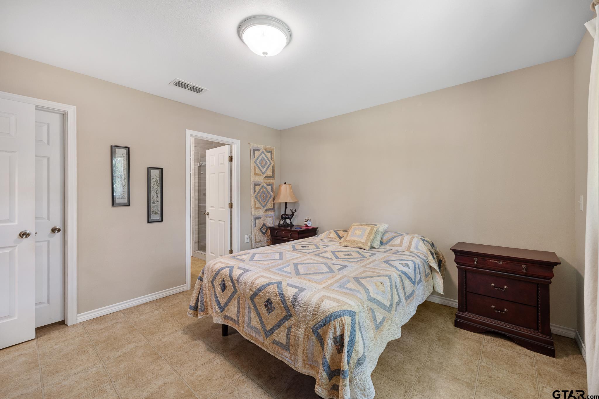 20650 West Grove Club Lake Road Whitehouse, TX 75791 - Photo 21 of 39 a bedroom with a bed and a tv