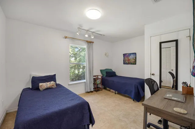 a bedroom with a bed and a table