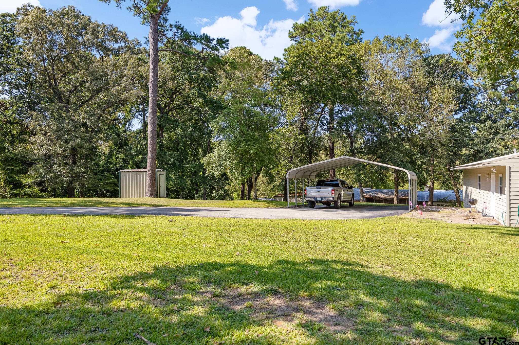 20650 West Grove Club Lake Road Whitehouse, TX 75791 - Photo 27 of 39 a view of a swimming pool and trees in the background