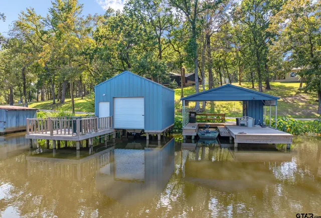 a view of a house with swimming pool and sitting area