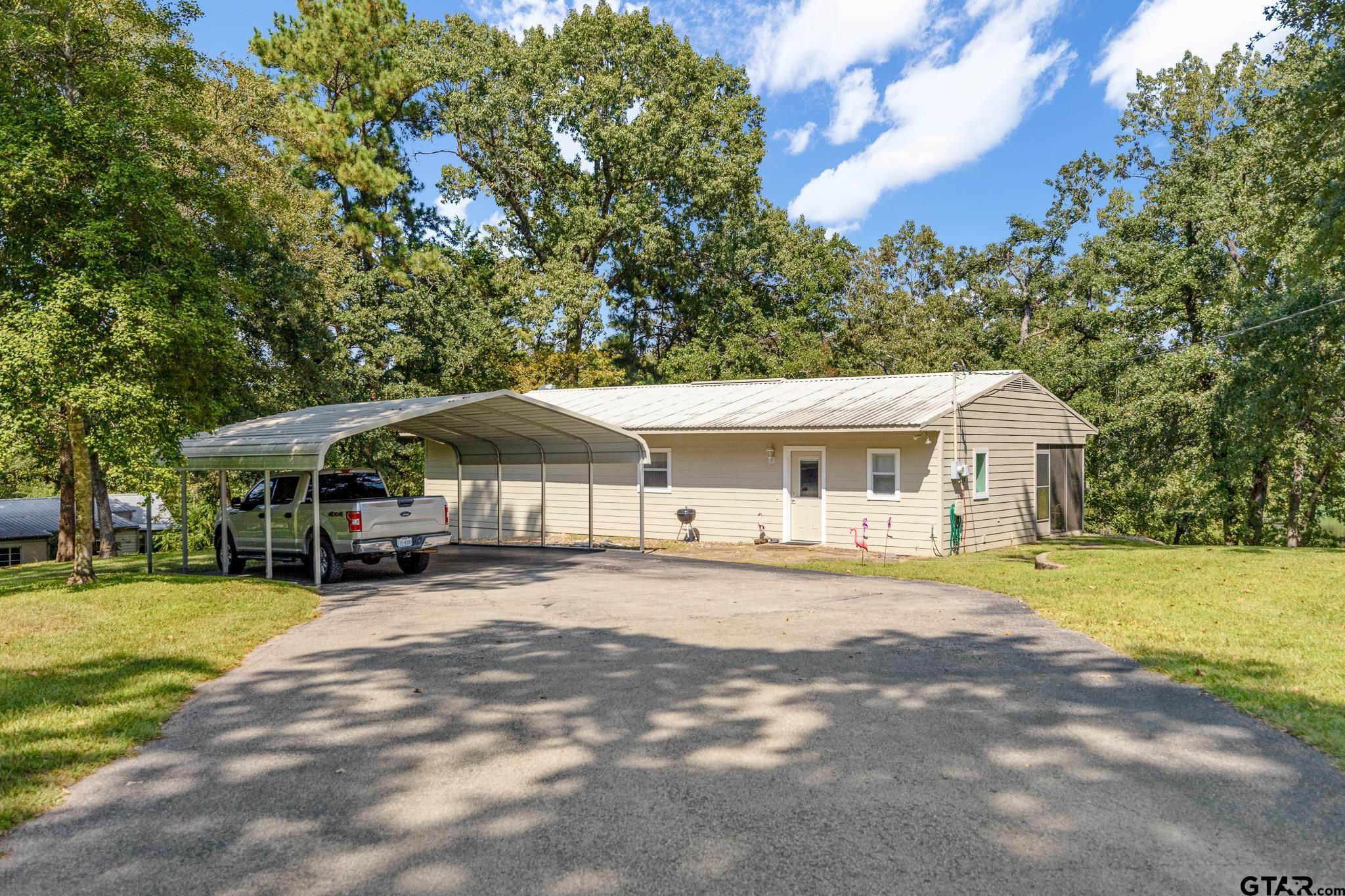 20650 West Grove Club Lake Road Whitehouse, TX 75791 - Photo 6 of 39 a front view of a house with a yard and trees