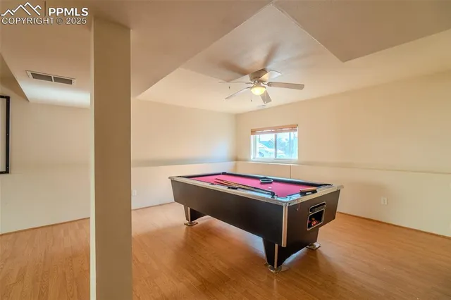 a room with pool table and a rug