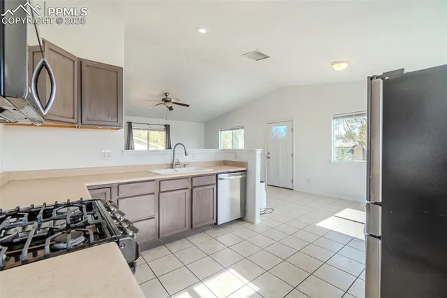 a kitchen with a sink a stove and cabinets