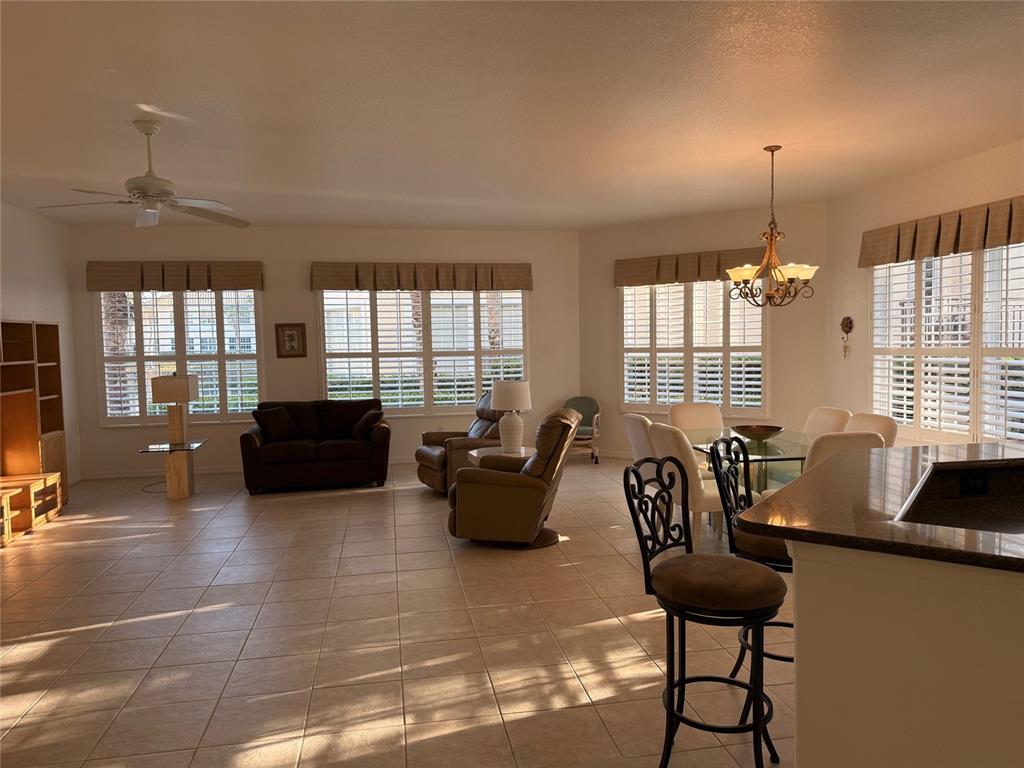 1802 Triano Circle, Unit 1802 Venice, FL 34292 - Photo 3 of 19 a living room with furniture and floor to ceiling windows