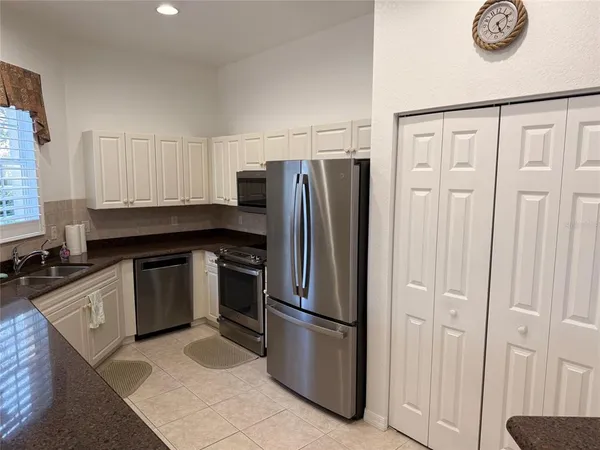 a living room with furniture and view of kitchen
