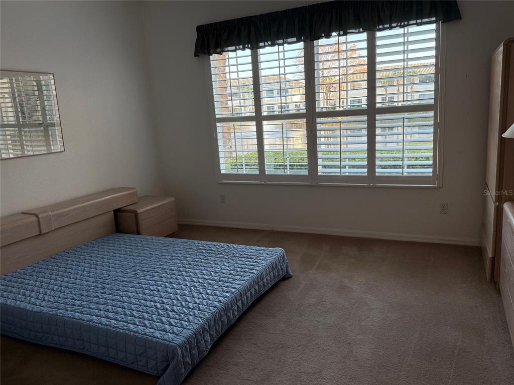1802 Triano Circle, Unit 1802 Venice, FL 34292 - Photo 9 of 19 a bedroom with a bed and window