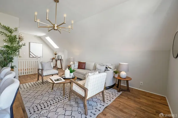 a living room with furniture and a chandelier