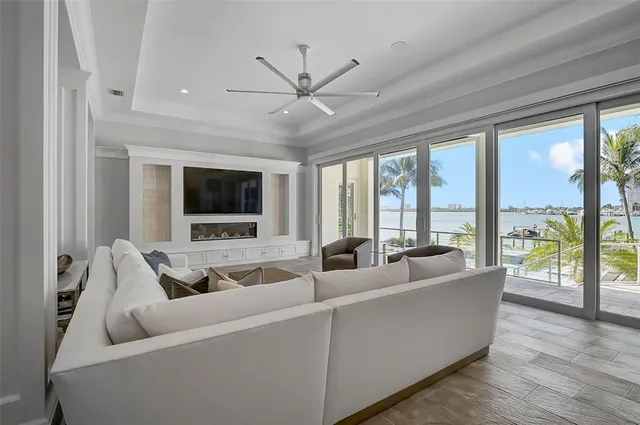 a room with furniture a flat screen tv and a window