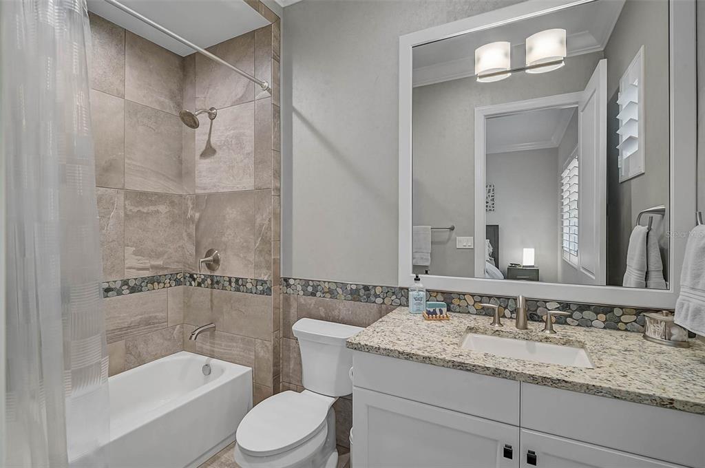 101 Seagull Lane Sarasota, FL 34236 - Photo 27 of 90 a bathroom with a granite countertop sink toilet and shower