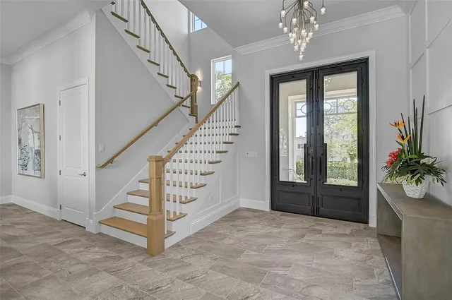 a large kitchen with kitchen island a dining table and chairs