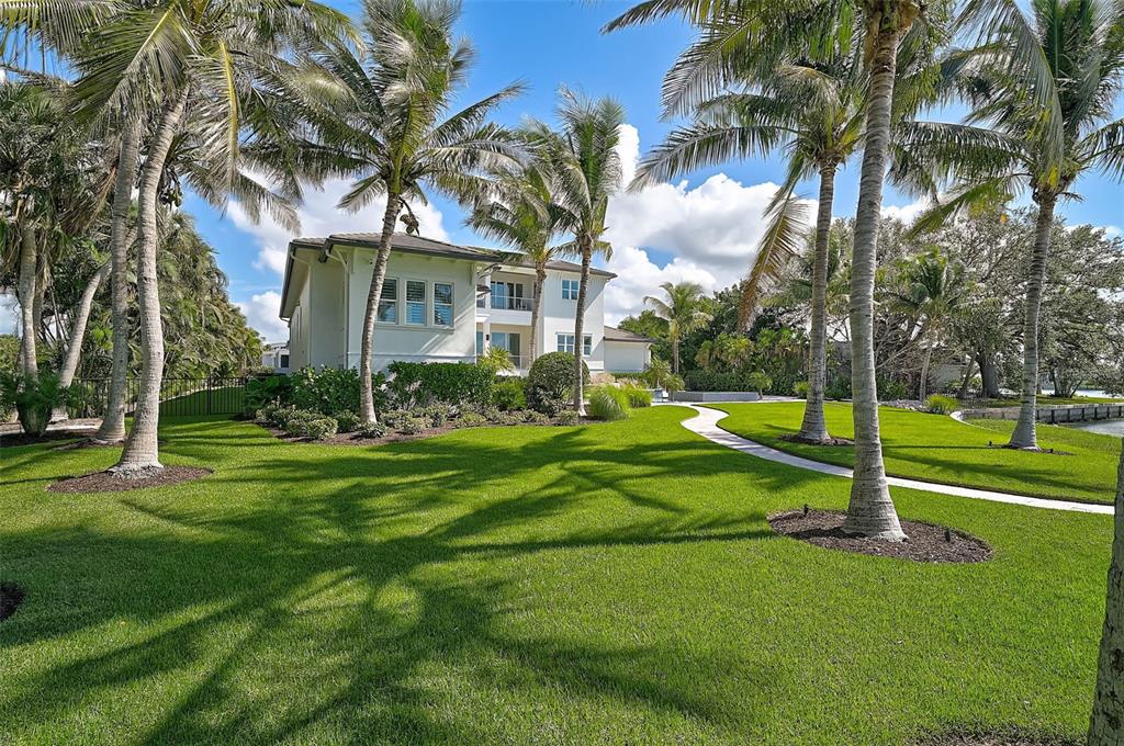 101 Seagull Lane Sarasota, FL 34236 - Photo 71 of 90 a view of a white house with a big yard and palm trees