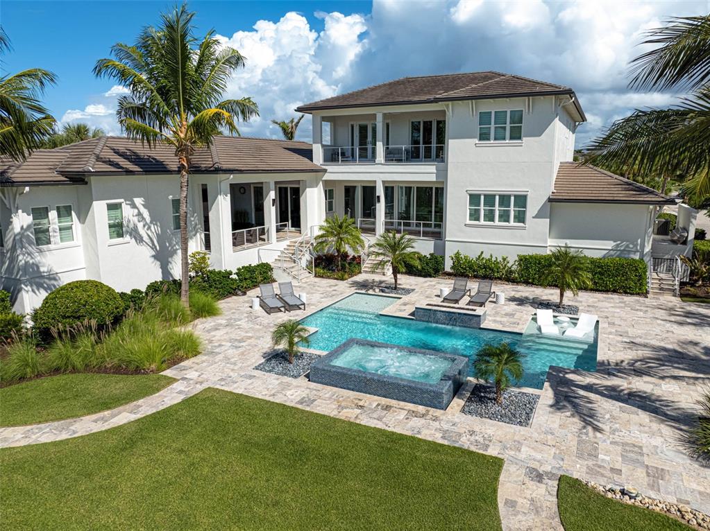 101 Seagull Lane Sarasota, FL 34236 - Photo 85 of 90 a front view of a house with garden and sitting area